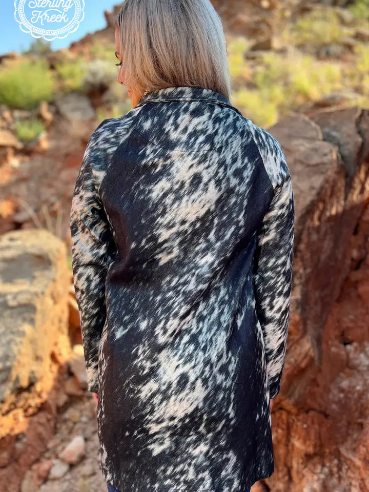 Fashionable long women’s western cardigan layered over a country style outfit with boots and denim for everyday western wear.