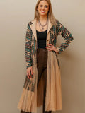 Woman wearing a flowing women’s western kimono styled with denim jeans and cowboy boots for a boho cowgirl fashion look.
