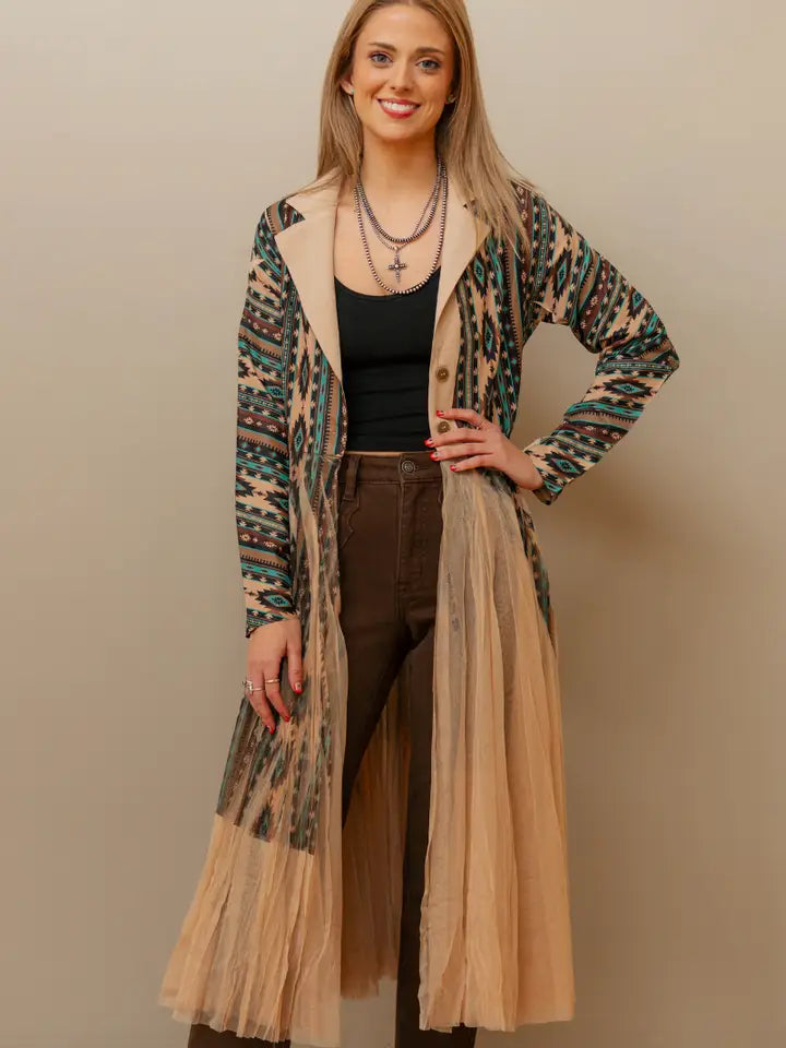 Woman wearing a flowing women’s western kimono styled with denim jeans and cowboy boots for a boho cowgirl fashion look.