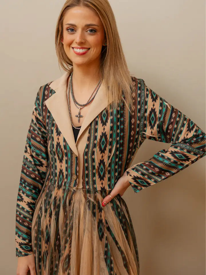 : Woman wearing a boho-inspired western kimono paired with jeans and boots for a relaxed cowgirl fashion style.