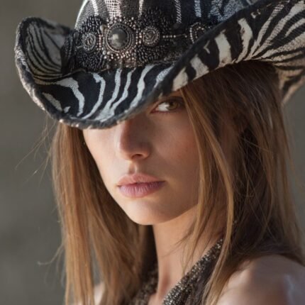 “Woman wearing a zebra cowboy hat styled with denim jacket and black boots”