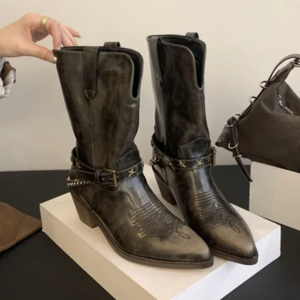 Roman cowboy boots in distressed brown leather with structured shaft and stacked Western heel.