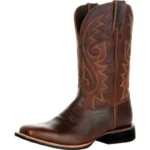 Stylish women’s rodeo boots in tan leather with embroidered Western patterns and mid-calf height.