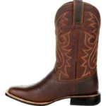 Women’s rodeo boots in rich brown leather with detailed Western stitching, pointed toe, and stacked heel.