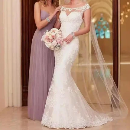 Bride wearing whimsical wedding dress with lace sleeves and flowing tulle skirt in a garden setting