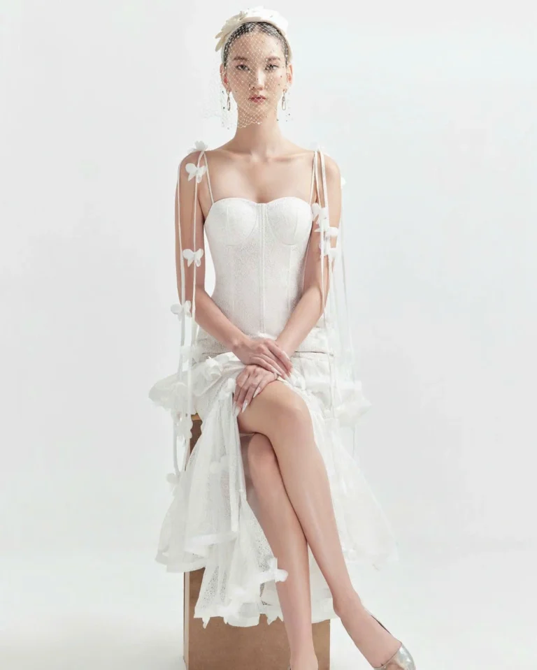 Elegant midi wedding guest dress in pastel pink with A-line silhouette and subtle lace details