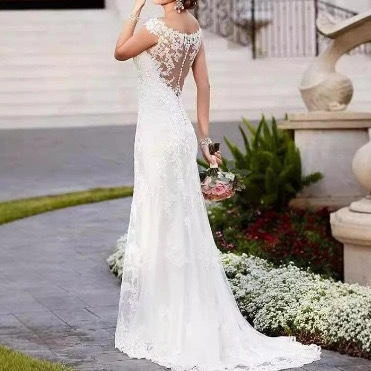 Ethereal whimsical fairy wedding dress with sheer long sleeves and floral embroidery