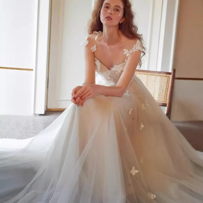Bride wearing a simple long sleeve wedding dress with lace detailing and flowing skirt