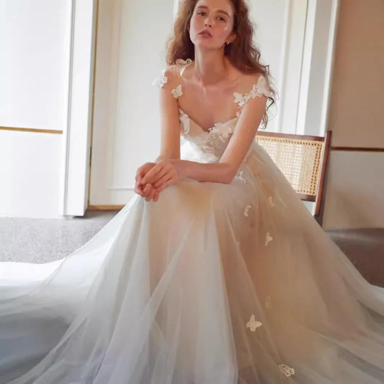 Bride wearing a simple long sleeve wedding dress with lace detailing and flowing skirt