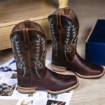 Cowhide hair on cowboy boots with natural black and white pattern and leather sole.