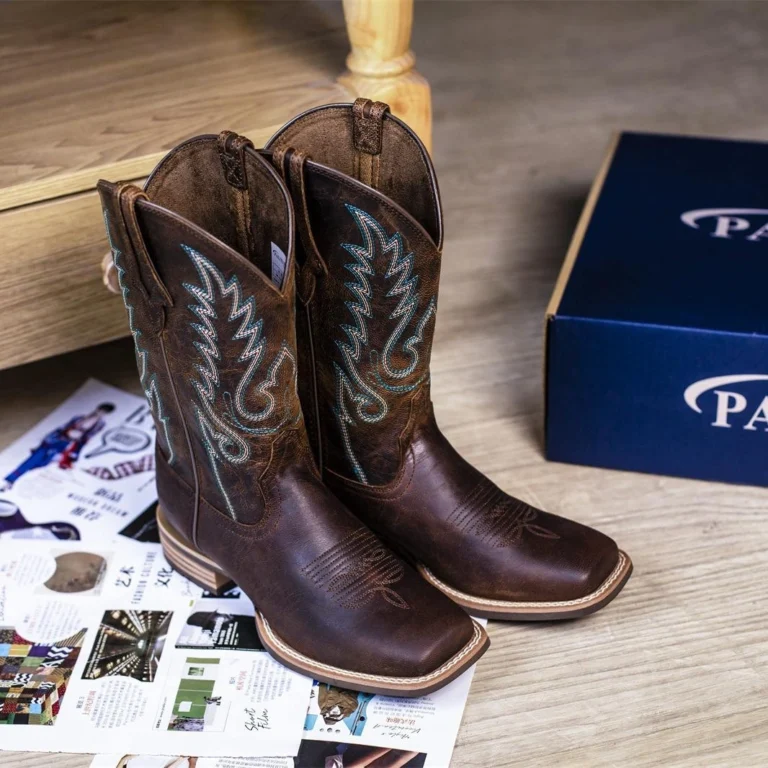 Brown mens cowhide cowboy boots with classic pointed toe and stacked leather heel.