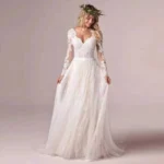 Elegant tulle ball gown wedding dress with long sheer sleeves and voluminous skirt
