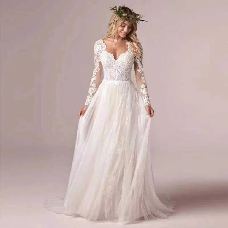 Elegant tulle ball gown wedding dress with long sheer sleeves and voluminous skirt
