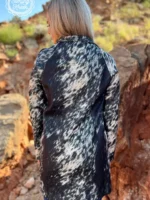 Fashionable long women’s western cardigan layered over a country style outfit with boots and denim for everyday western wear.