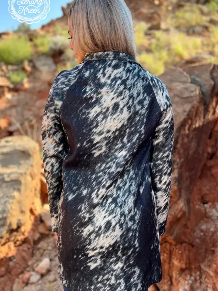 Fashionable long women’s western cardigan layered over a country style outfit with boots and denim for everyday western wear.