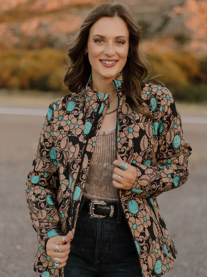 Woman wearing a tailored women’s western blazer styled with cowboy boots and denim jeans