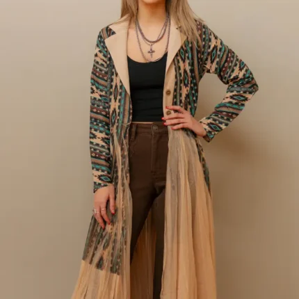 Woman wearing a flowing women’s western kimono styled with denim jeans and cowboy boots for a boho cowgirl fashion look.