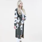 Curvy woman wearing a long Aztec print hoodie cardigan styled for plus size western wear fashion with boots and jeans.