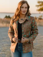 Woman wearing a tailored ladies western blazer paired with cowboy boots and western fashion accessories.