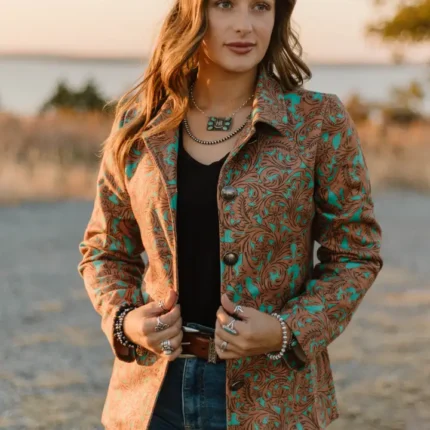 Woman wearing a tailored ladies western blazer paired with cowboy boots and western fashion accessories.