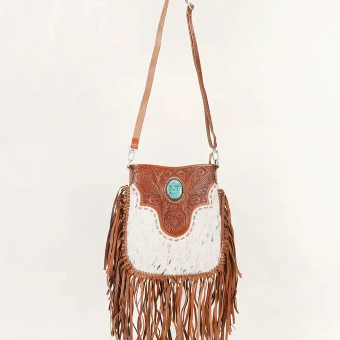 Stylish Rodeo Queen Handbag paired with cowboy boots and western-inspired fashion accessories for a classic cowgirl look.