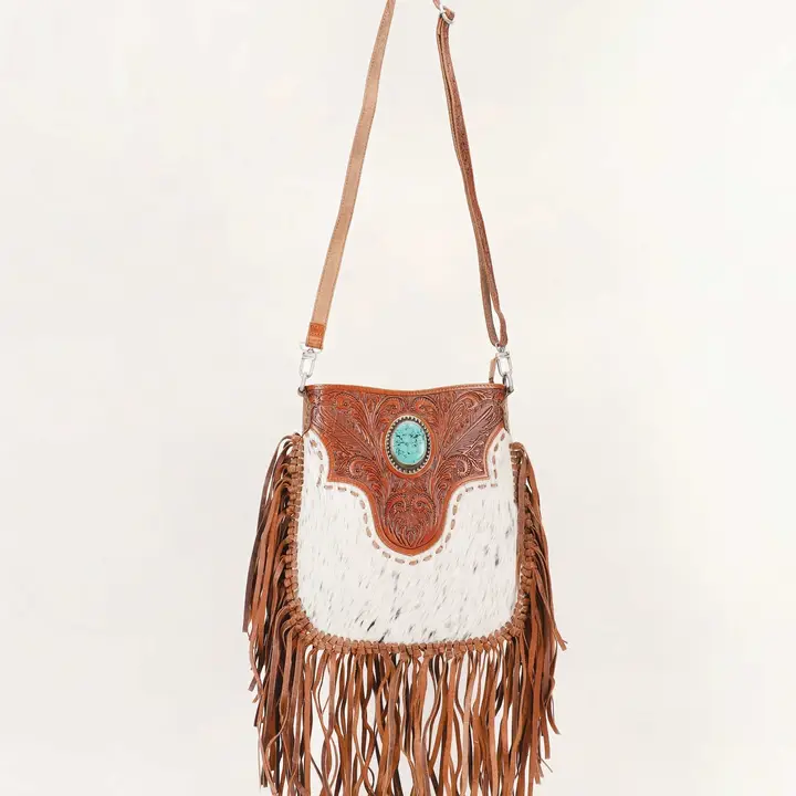 Stylish Rodeo Queen Handbag paired with cowboy boots and western-inspired fashion accessories for a classic cowgirl look.
