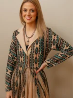 : Woman wearing a boho-inspired western kimono paired with jeans and boots for a relaxed cowgirl fashion style.
