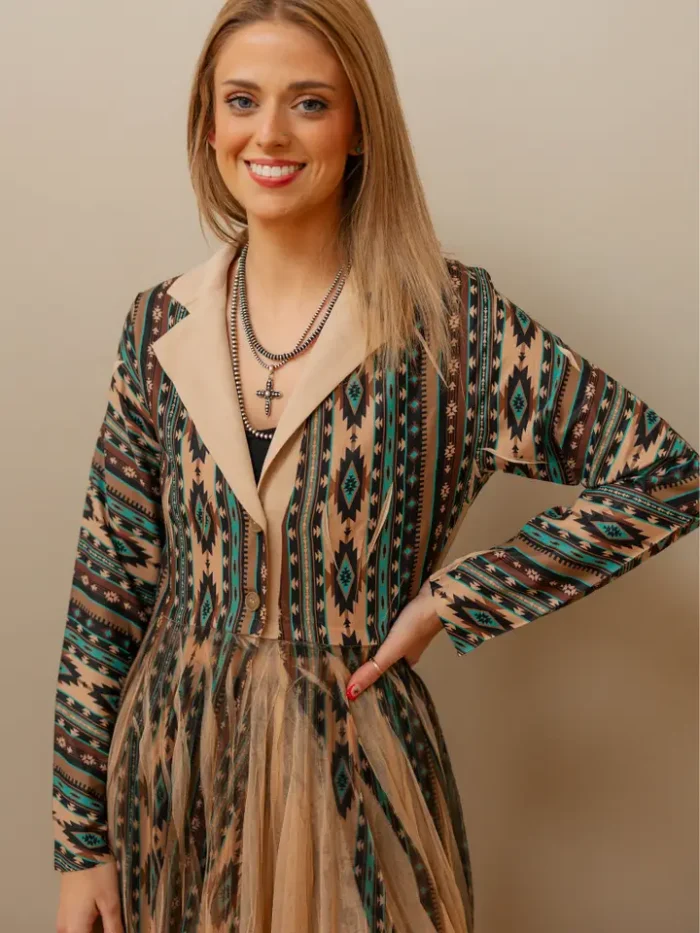 : Woman wearing a boho-inspired western kimono paired with jeans and boots for a relaxed cowgirl fashion style.