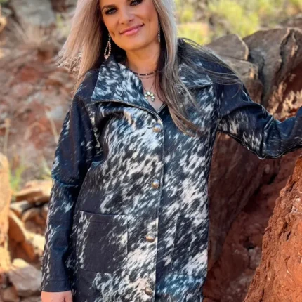 Woman wearing an Aztec patterned women’s western cardigan styled with denim jeans and cowboy boots for a cozy cowgirl look.