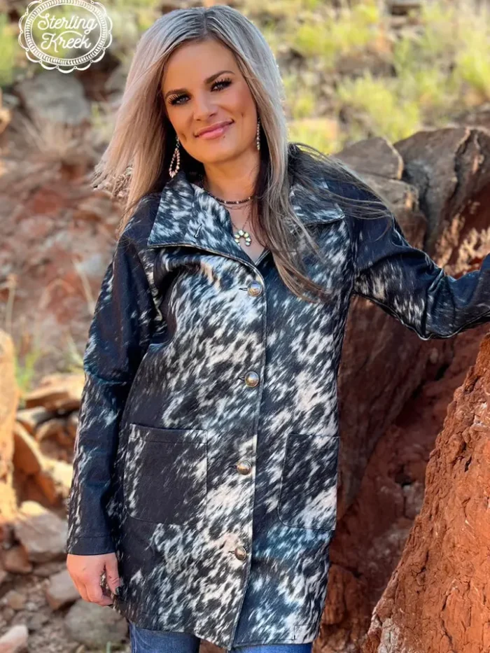 Women’s Western Aztec Cardigan Style Woman wearing an Aztec patterned women’s western cardigan styled with denim jeans and cowboy boots for a cozy cowgirl look.