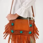 Elegant Country Charm Handbag styled with cowboy boots and denim for a classic western cowgirl fashion look.
