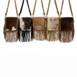 Brown leather western crossbody bag featuring long fringe accents, adjustable strap, and rustic cowgirl-inspired design.