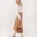 Stylish Frontier Fashion Bag paired with cowboy boots and denim jeans for a classic western cowgirl outfit.